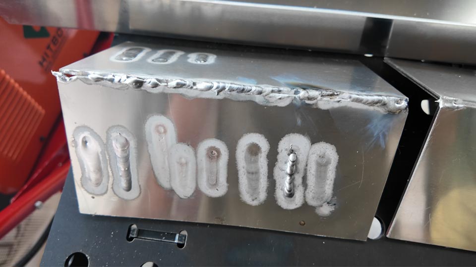 Some practice aluminium welds on a piece of aluminium angle