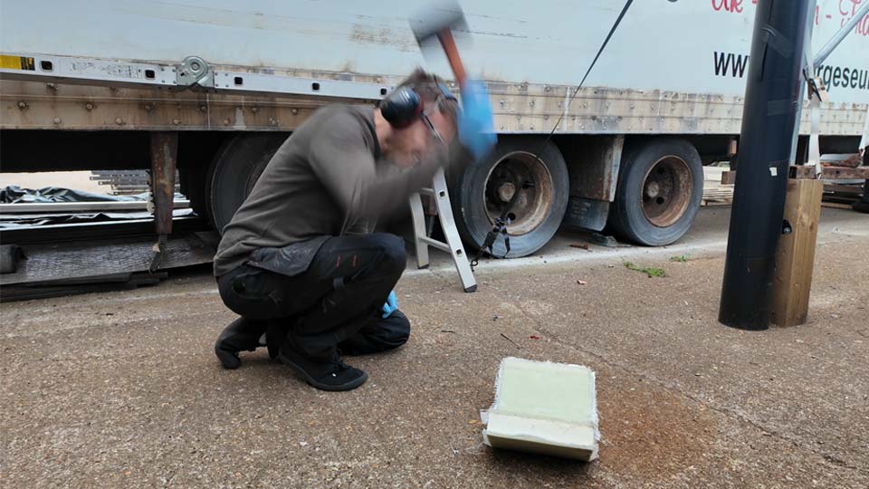 Pete tests the strength of fibreglass with a mallet