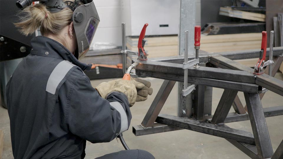 Hayley welding some trailer crossmembers