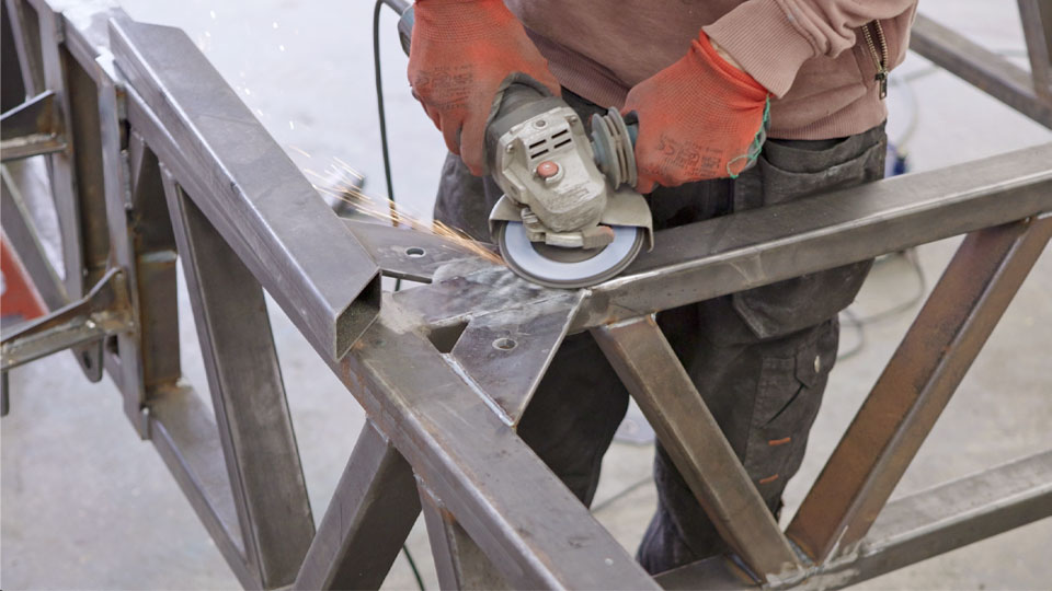 Pete grinds the welds on our habitat mounts