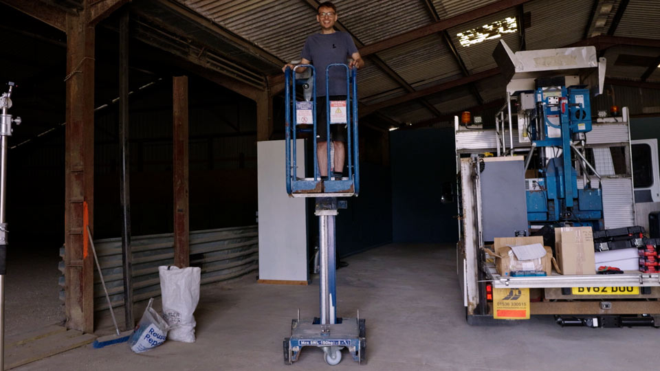 Pete in a manual mast lift