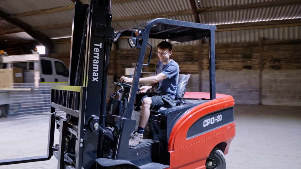 Pete tears around the workshop on his new electric forklift truck