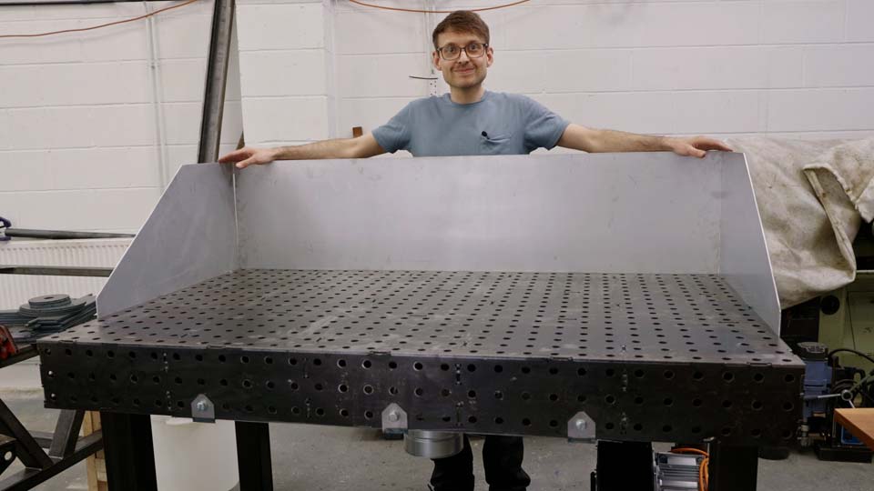 An aluminium grinding dust shroud on a welding fixture table