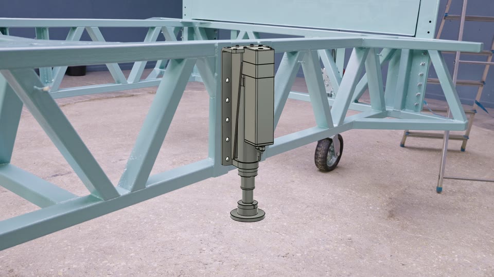 Mock-up of an electric levelling actuator bolted to the side of our teal tiny house trailer chassis